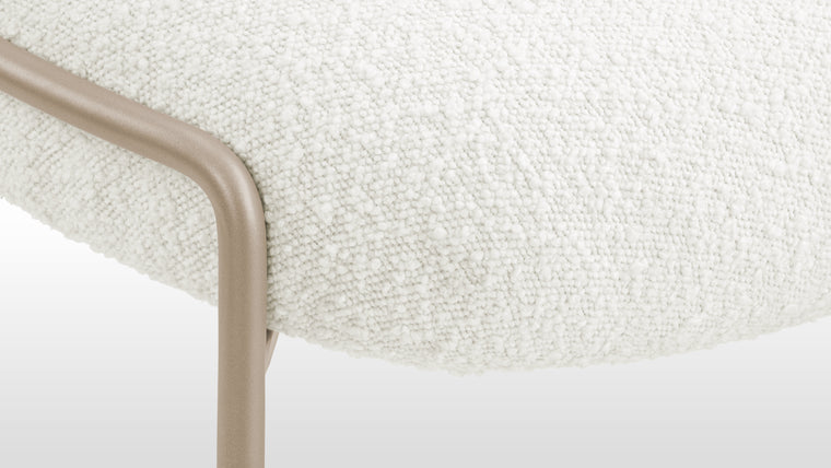 Pure Elegance | Versatility is a key feature of the Arielle Side chair. The chair seamlessly adapts to its surroundings, enhancing the aesthetic of any environment. The white boucle upholstery adds an element of purity and timelessness to the Arielle Side chair.
