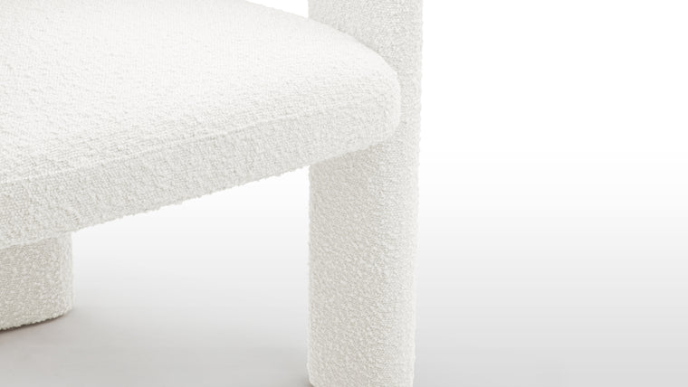 Contemporary Elegance | Draped in luxurious white bouclé fabric, the Dudet Chair takes on an air of sophistication and modernity. The tactile allure of bouclé adds a layer of comfort and opulence, while the choice of white ensures a timeless and versatile appeal that seamlessly integrates into various design schemes.
