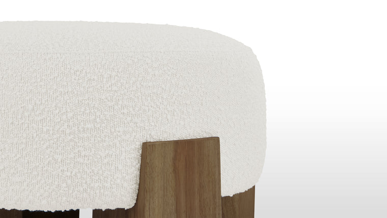 Rich Shades and Texture | A striking contrast between natural wood and plush material, the Liv Ottoman is crafted from thick walnut supports to create an impressive and sturdy frame, softened by richly textured fabric.
