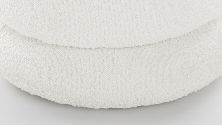 Textural Appeal | Upholstered in a boucle fabric, this ottoman offers both comfort and textural interest, its downy feeling enhancing the overall tactile experience.
