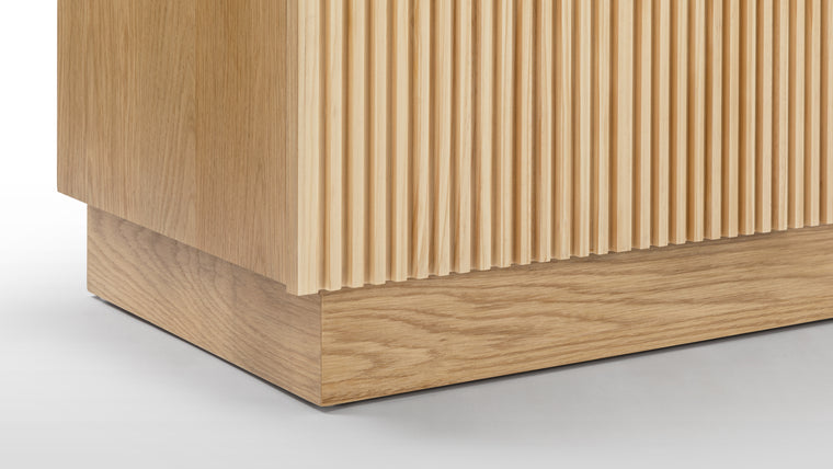 Warmth and Structure | The sideboard boasts a light finished oak color, adding a natural, warm tone to its design while ensuring durability and longevity in its materials. The stylish facade recalls iconic art deco shapes in architecture.
