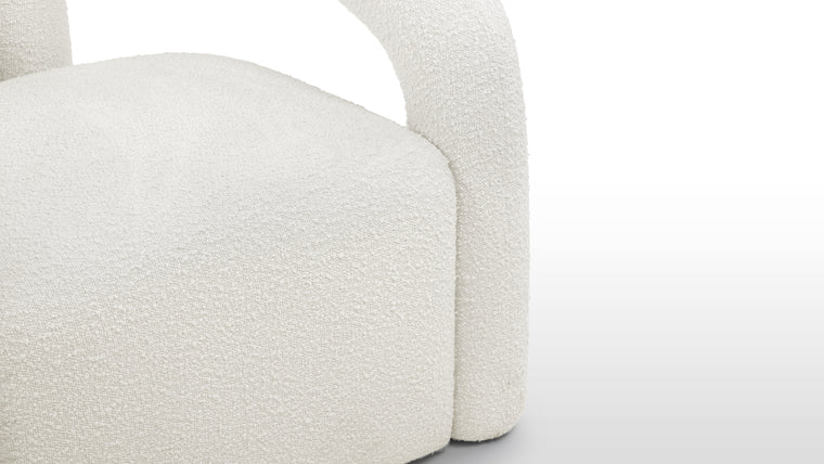 Luxurious Texture | This chair is upholstered in a boucle fabric, known for its looped and textured surface, providing both comfort and a plush aesthetic. The warm white color adds to its refined and inviting appearance.
