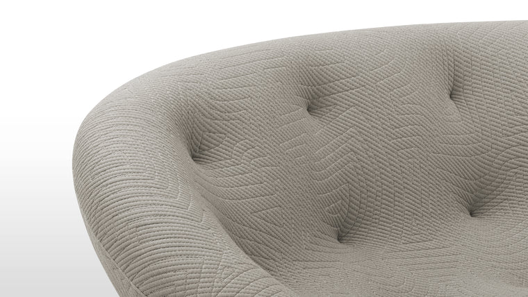 Tactile Textiles | Constructed using a combination of high-resilience foam and multi-density foam, the sofa offers a plush, enveloping feel. The upholstery, a stretchable jersey, enhances the sofa's ergonomic properties, allowing it to adapt to the body's contours seamlessly. This choice of fabric not only provides comfort but also adds to the sofa's modern, textured appearance.
