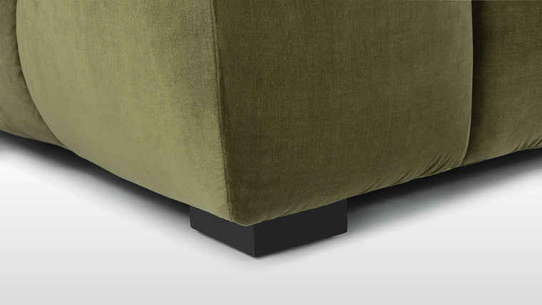 Velvet Reverie | The plush olive green velvet upholstery adds a touch of extravagance, infusing the room with rich color and texture. Each sink-worthy cushion beckons you to unwind, promising hours of blissful lounging and unwavering comfort.
