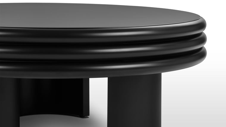 Graceful Details | At first glance, the Pascal Round Coffee Table's round silhouette exudes a sense of harmony and balance, inviting you to explore its intricate details. The tabletop, a masterpiece in itself, boasts a distinctive stacked design that adds depth and visual interest.
