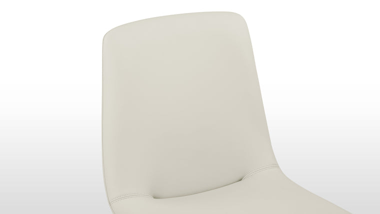 Enduring Comfort | Ergonomically curved for full body support and padded for long-lasting comfort, the design's versatile forms—side chair, armchair, or stool—make it an adaptable piece for various spaces.
