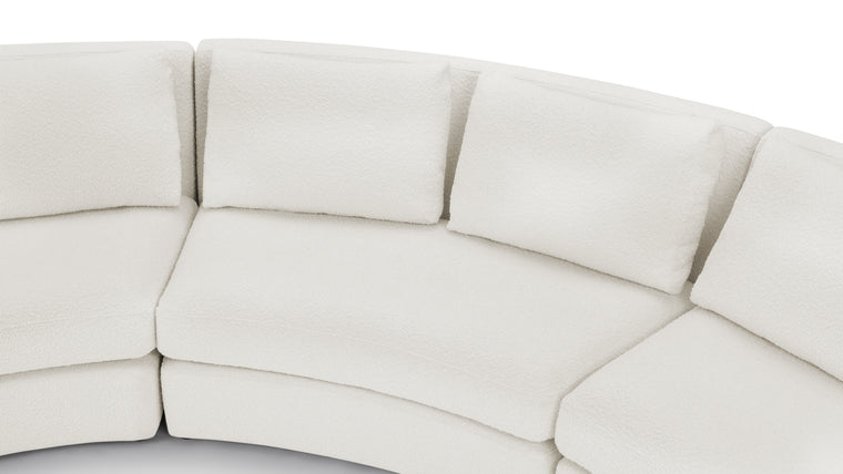 Textured Sophistication | Crafted from soft boucle fabric, the sectional exudes a tactile richness while maintaining a sleek European-inspired silhouette. The fabric’s warm white hue adds both comfort and contemporary visual appeal.
