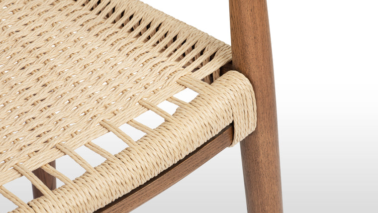 Beauty in the Details | The quality of the The Round Chair can be seen in its refined details. From the gentle splay of the back legs to the tapered arm rests, every aspect of the design is finessed. Made from solid Ash with a hand-woven paper cord seat, this chair is made to last; buy for yourself, and hand down to future generations.
