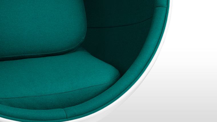 Color Contrast|Inside its white half-sphere, this unique chair features vibrant upholstery for a beautiful pop of color.
