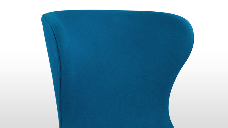 Bright and Vibrant | Upholstered in rich blue wool, the chair features black tapered legs for a sharp contrast. The padded seat and rounded arm edges provide comfort, showcasing high-quality materials with a modern flair.
