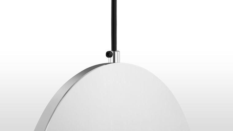 Shining Surfaces | Crafted from stainless steel with an option of chrome or gold finish, the pendant features an acrylic face that allows light to pass through while complementing its durable and luxurious materials.
