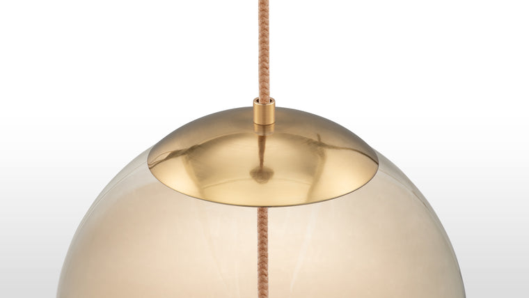 Refined Craftsmanship | This pendant is crafted from high-quality materials, featuring a gentle amber-colored glass, durable iron fittings with a brass finish, and unique rope detailing for added texture.
