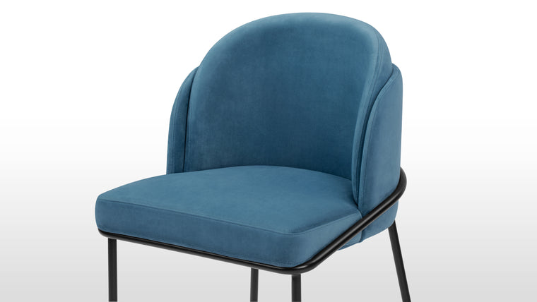 Stylish Comfort | The widely curved back encourages reclining, promising comfort through hours of sitting. With a smooth seat and a backrest that features an additional padded section, the Aben Dining Chair offers increased support.
