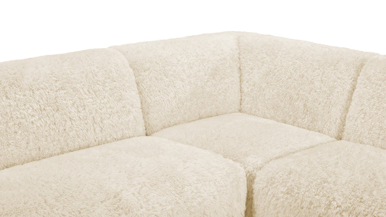 Material Harmony | Crafted with meticulous attention to detail, the Iona Sectional is upholstered in faux sheepskin, a soft and sumptuous material that not only feels luxurious but also radiates an inviting warmth. Its light cream tone adds an air of sophistication and minimalism, blending seamlessly with diverse décor styles.
