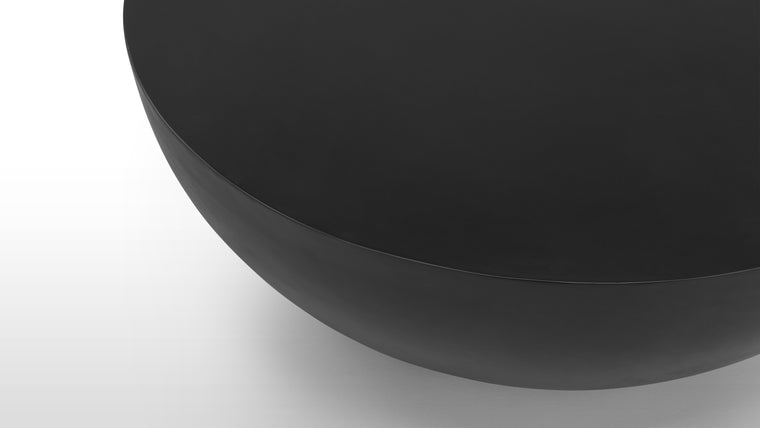 Industrial Elegance | Made from black concrete, this table boasts a smooth matte finish and a unique bowl-inspired design, encapsulating industrial and modern elegance.
