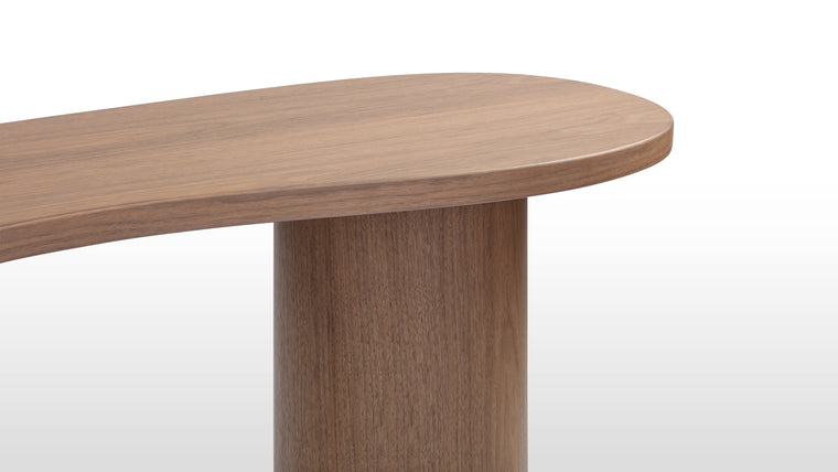 Rich and Organic | Crafted from walnut veneer, this table exudes warmth with its rich grain and organic kidney-shaped top, paired with bold cylindrical legs that enhance its contemporary, minimalist appeal.
