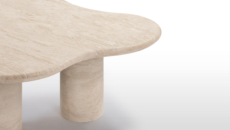 Flowing Together | The table's travertine material, with natural beige tones and intricate cloud-like patterns, lends it a refined elegance. Its smooth, flowing curves and polished finish highlight a blend of artistry and simplicity.
