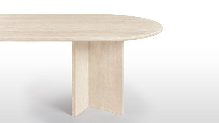 Harmonious Profile | Crafted from durable stone in warm, neutral hues, the Maui Dining Table radiates modern elegance. Its rounded surface and angular legs create a striking yet harmonious contrast.
