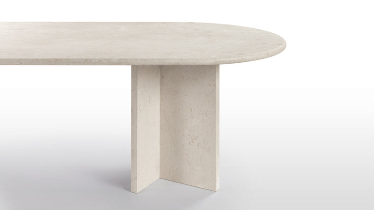 Harmonious Profile | Crafted from durable stone in warm, neutral hues, the Maui Dining Table radiates modern elegance. Its rounded surface and angular legs create a striking yet harmonious contrast.
