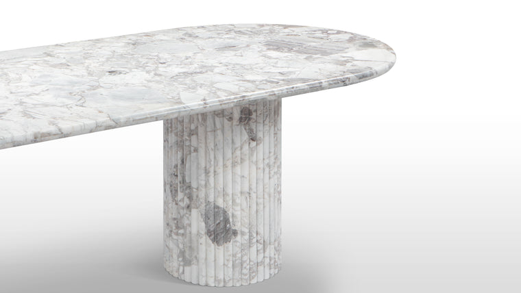 Natural Marble | Made from honed natural marble, this beautiful contemporary table makes a stunning centerpiece. Featuring a large oval top and a reeded pedestal base, it is a great choice for considered, modern homes.
