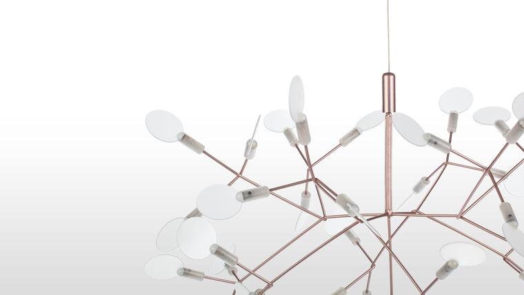 Sculpted Radiance | Crafted from stainless steel with a copper finish, the chandelier’s delicate acrylic shades diffuse the soft LED glow, evoking the ethereal quality of dandelion seeds in flight.
