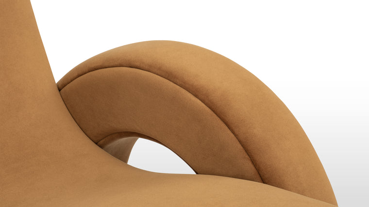 Merging Design Styles | This chair features luxurious velvet upholstery, foam padding, and a solid wood frame, paired with a playfully sculptural design that merges retro warmth and contemporary flair.
